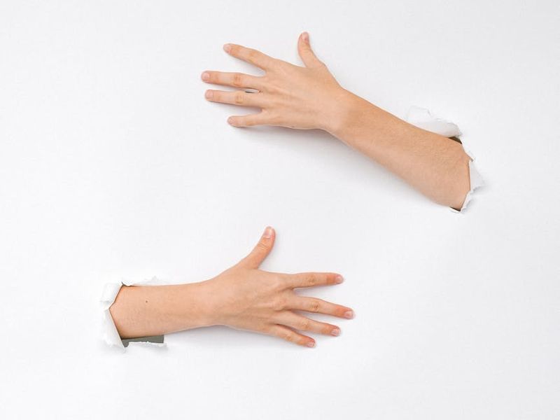 Person performing a fluid, dynamic movement in a minimalist space.